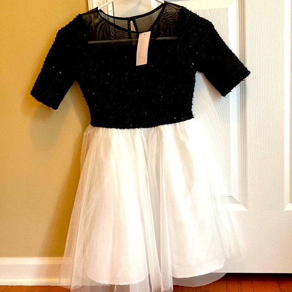 NWT beautiful size 10 girl’s dress. Top is embellish with sequins black & gold